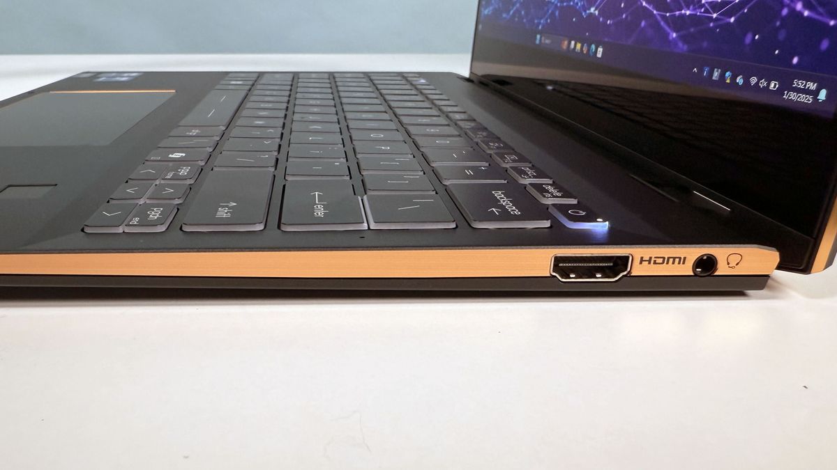 Close up of the right-hand ports on the MSI Summit 13 AI+ Evo (A2VM) 2-in-1 AI PC laptop, on a white desk, against a blue backdrop.