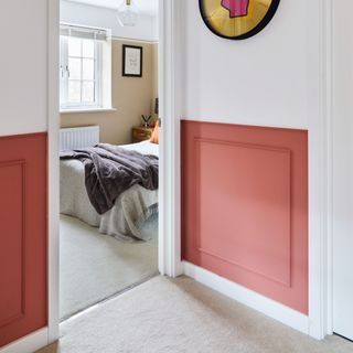 Two tone walls white and red panel moulding effect looking into bedroom doorway