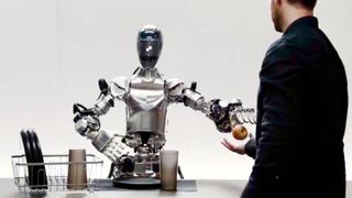 Artificial intelligence robot (left) hands an apple to a man (right).