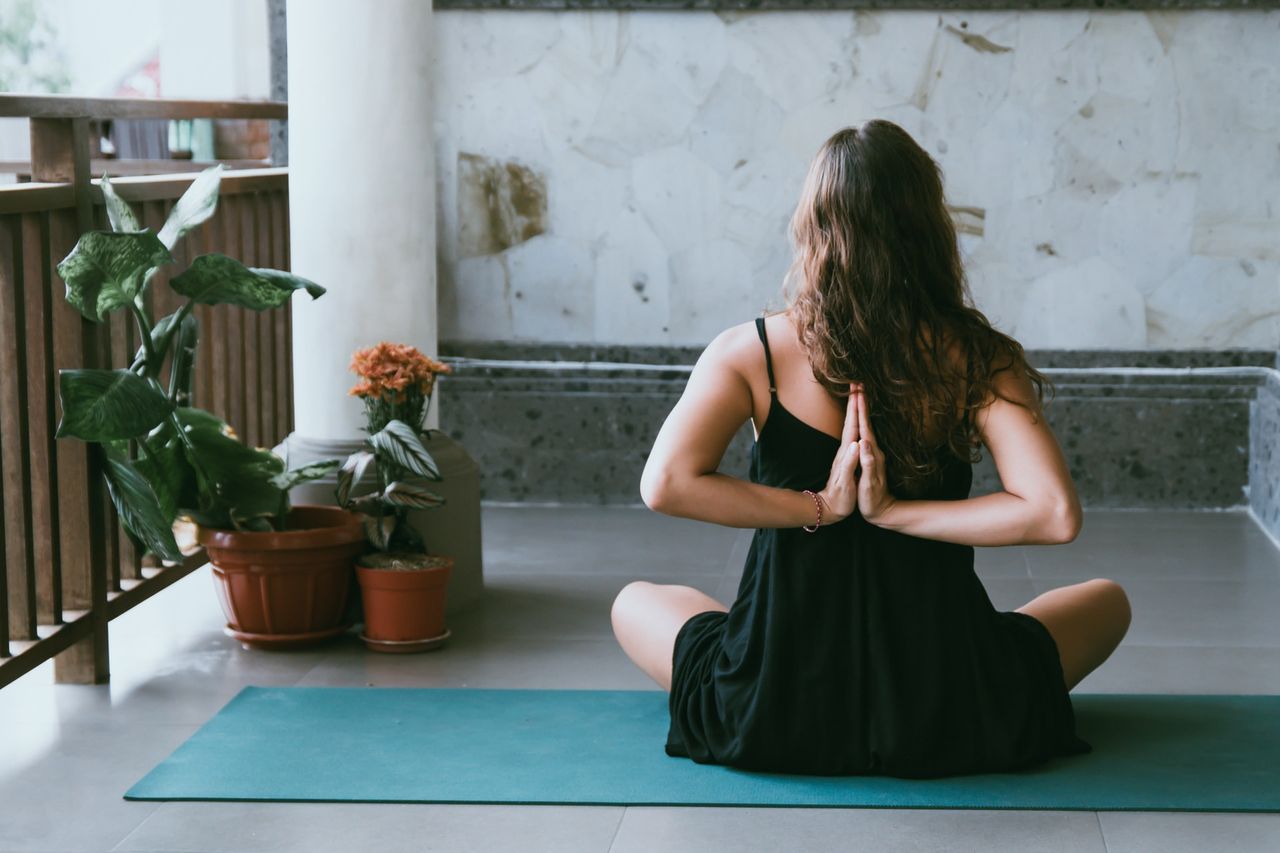 woman posing on blue yoga mat