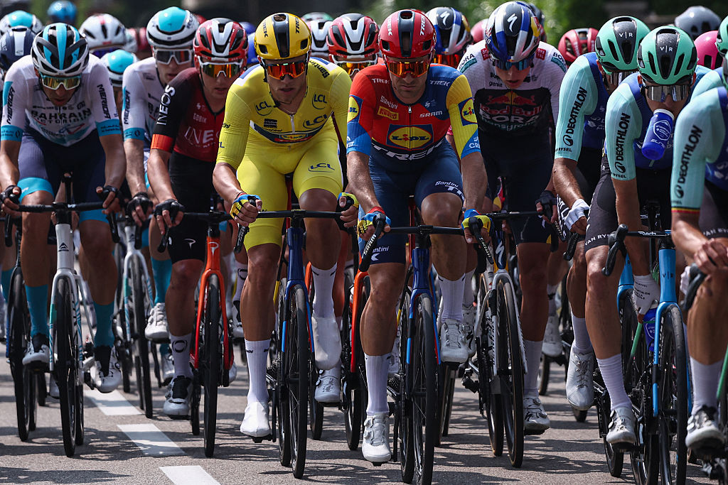 Lidl-Trek's Italian rider Jonathan Milan (C) wearing the overall leader's yellow jersey cycles with the pack during the 3rd stage of the 77th edition of the Criterium du Dauphine cycling race, 207,2 km between Brioude and Charantonnay, on June 10, 2025. (Photo by Anne-Christine POUJOULAT / AFP)