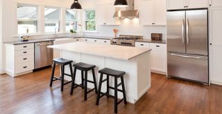 white kitchen with wooden flooring to highlight a kitchen trend to avoid 2023
