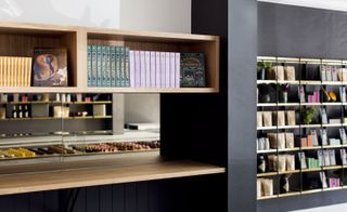 Wooden shelving displaying a range of cookbooks