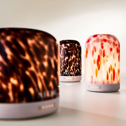 three of the neom wellbeing electric diffusers