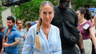 Sarah Jessica Parker wears a blue shirt dress with her hair in a side braid