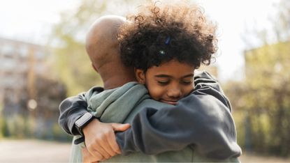 Father and son share a hug
