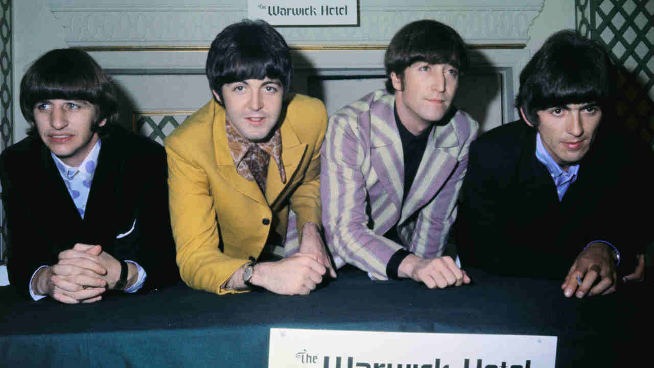 The Beatles posing for a photograph in 1966