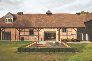 brick and timber barn conversion with sunken garden living space