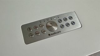 Audio Pro C20 wireless speaker remote control on top of speaker