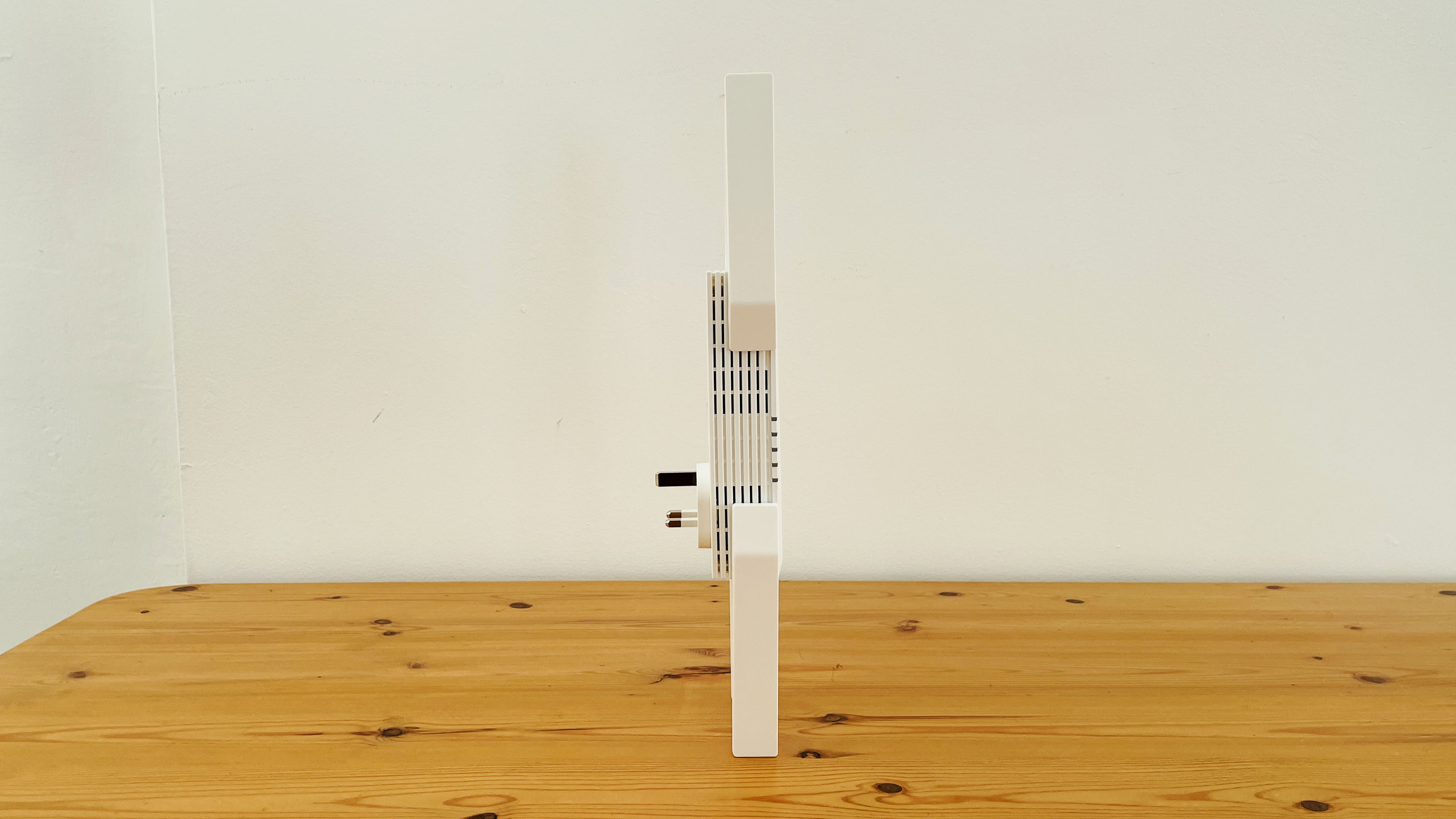 TP-Link AXE5400 range extender on wooden table