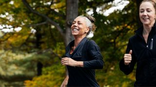 Woman smiling and running with friend