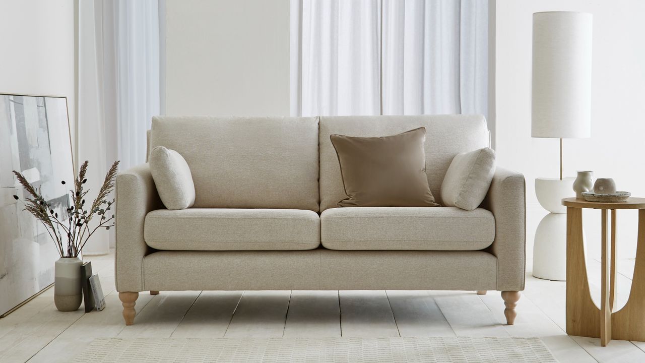 A cream sofa in a neutrally decorated living room