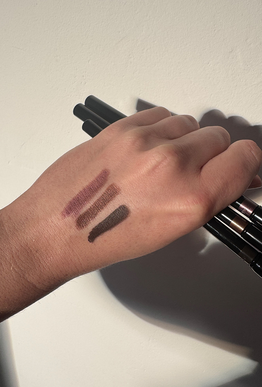 Swatches of the Victoria Beckham Beauty Satin Kajal Liners on the back of a hand