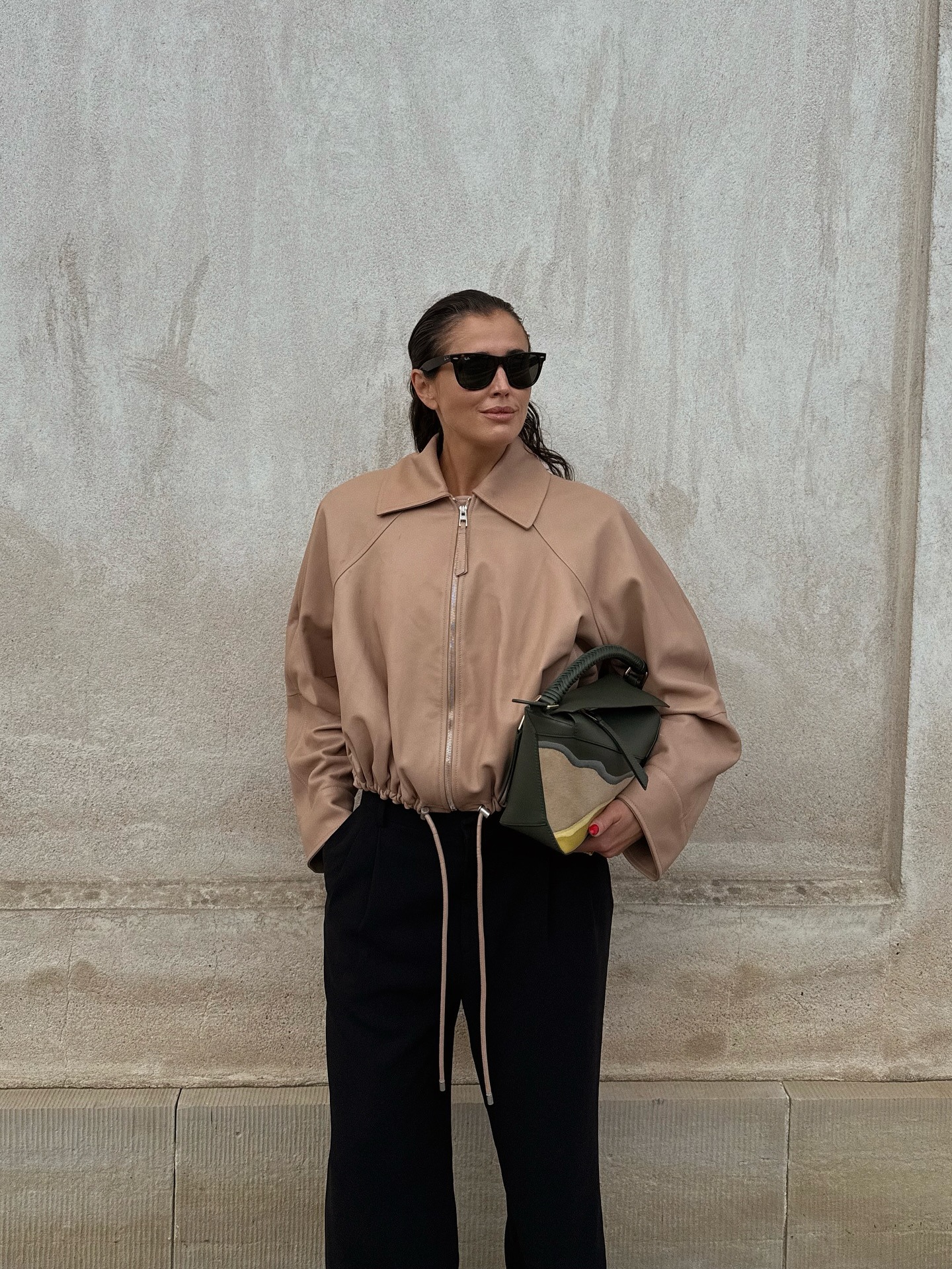 Woman in blouson jacket and black pants