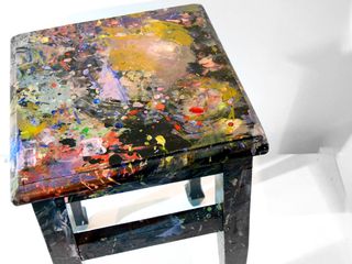 Stool with paint splashes on top