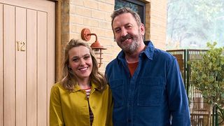 Lee (Lee Mack) and Lucy (Sally Bretton) stand in front of their house in Not Going Out