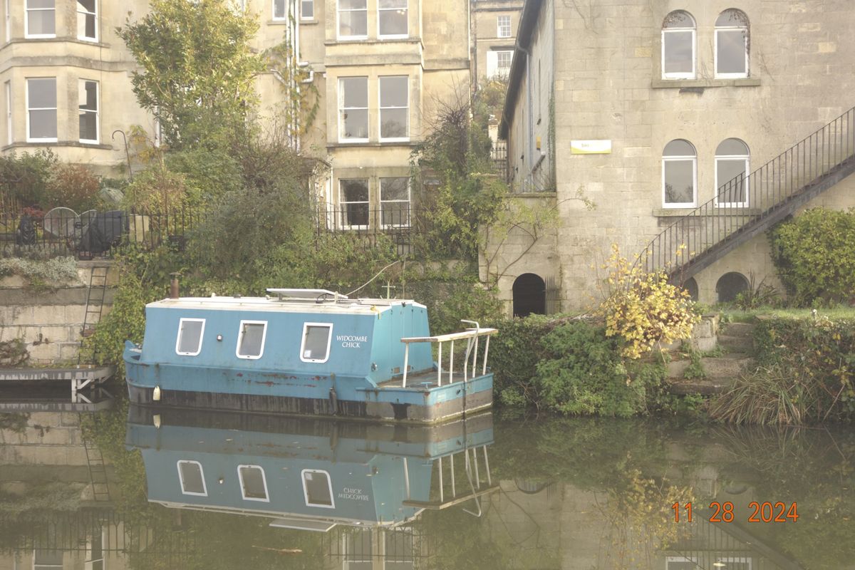 Canal boat in the city of Bath, UK, with retro photo picture effect