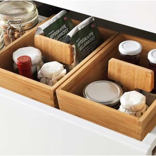 wooden under-cupboard drawers containing coffee and various glass jars