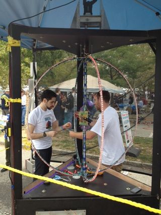 Two "makers" work on their Orbital Rendersphere at World Maker Faire at the New York Hall of Science on Sept. 21, 2013. The Rendersphere is a massive spherical display with over 400 LED lights that spin at more than 450 RPM to suspend visuals and games in
