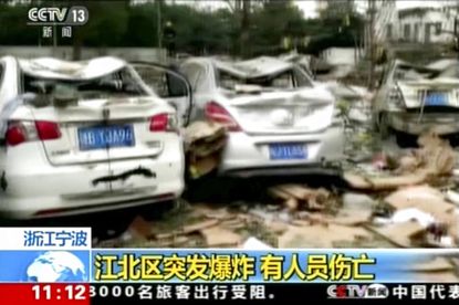 This image from video run by China's CCTV shows debris and damaged vehicles following an explosion in Ningbo in east China's Zhejiang province, Sunday, Nov. 26, 2017. 