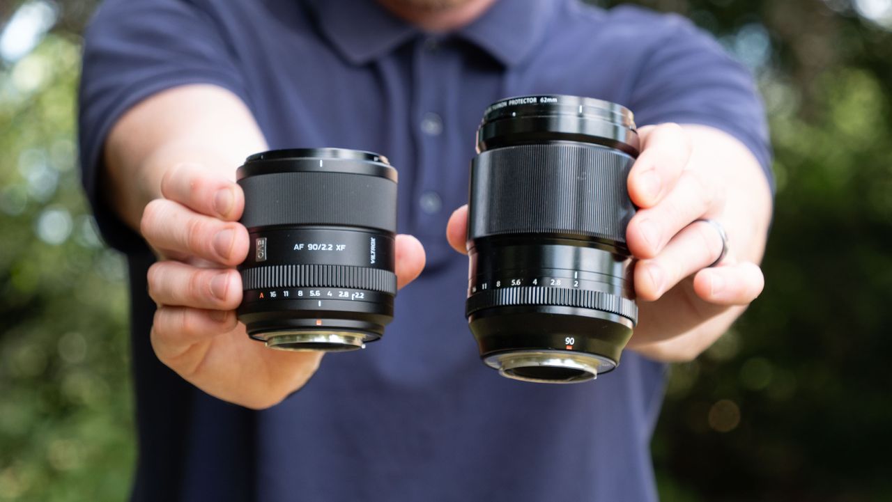 Viltrox AF 90mm f/2.2 EVO lens held alongside the Fujifilm XF 90mm f/2 lens by tech journalist and pro photographer Tim Coleman