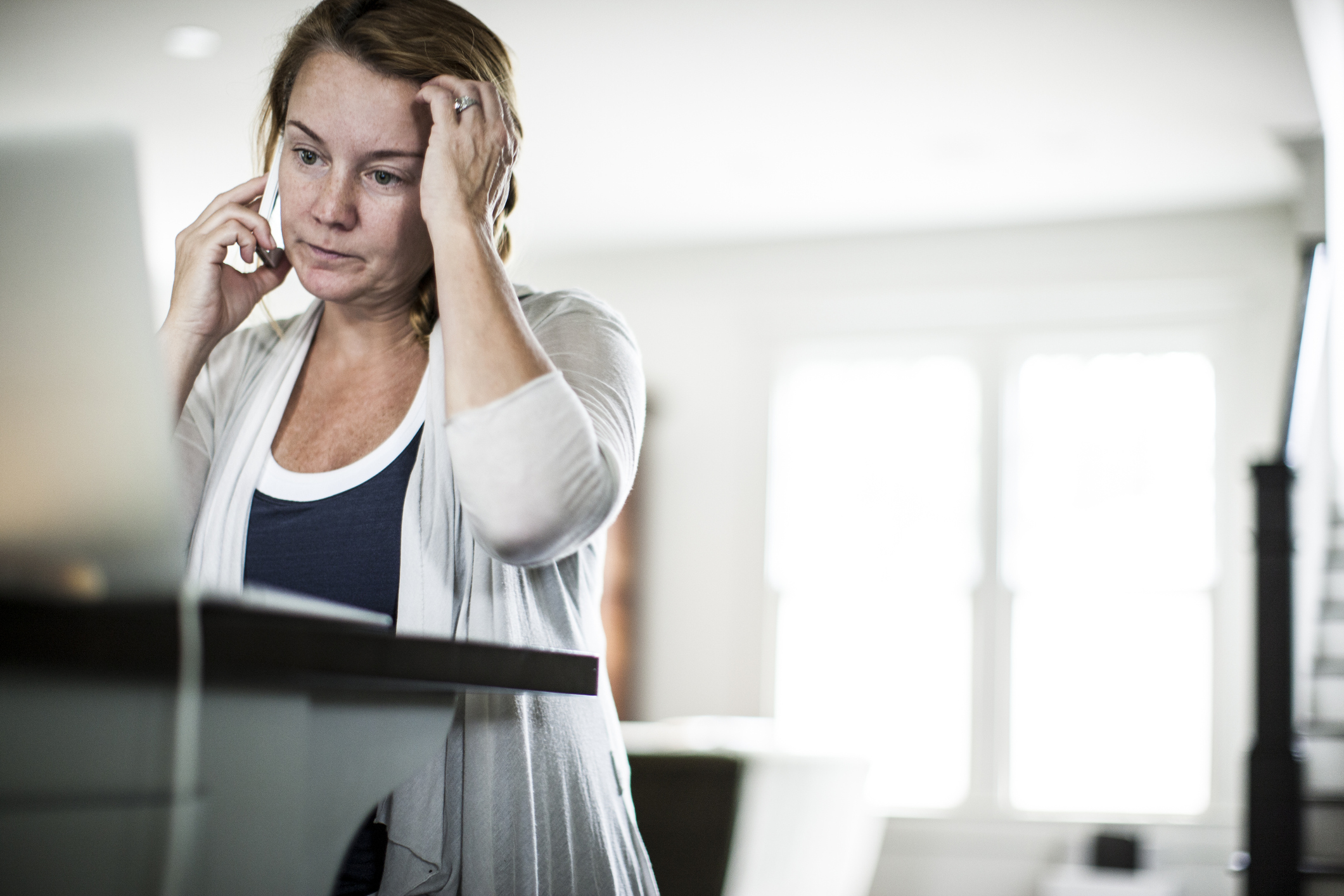 Woman is frustrated with customer service connection over VoIP phone