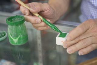 Painting a mahjong set- green paint and pot