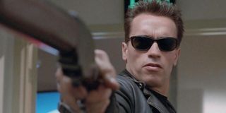 Arnold Schwarzenegger as Terminator in sunglasses, pointing gun