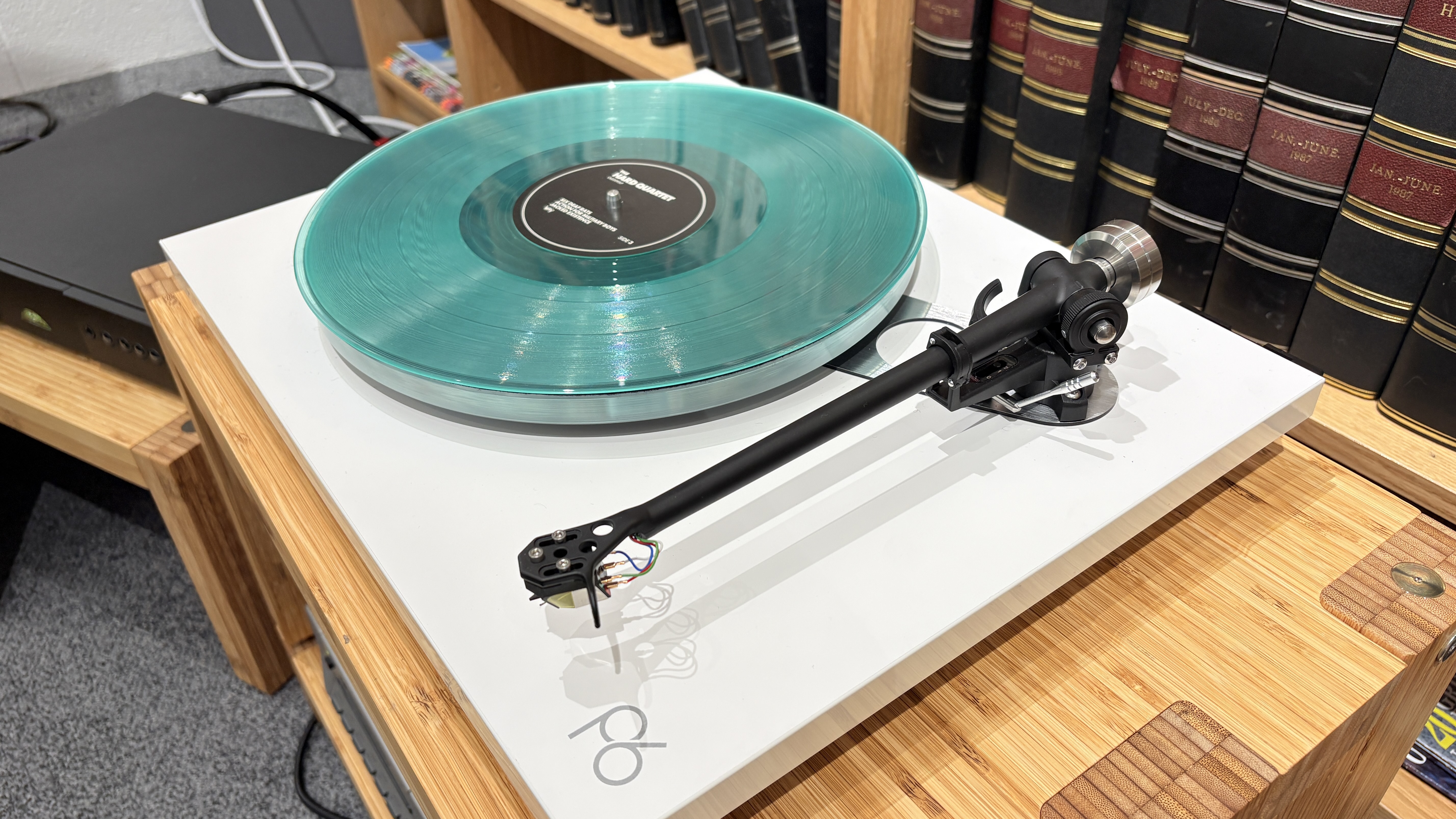 Rega Planar 6/Nd7 in white finish with blue vinyl record playing