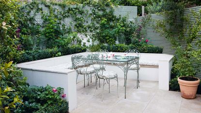 garden privacy ideas: green fence panels around seating area