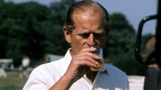 Prince Philip, Duke of Edinburgh enjoys a drink at Royal Windsor Horse Show on May 15, 1982 in Windsor, England