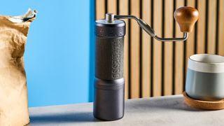 the 1ZPresso J-Ultra coffee grinder with foldable handle and external adjustment dial for easy grind adjustment