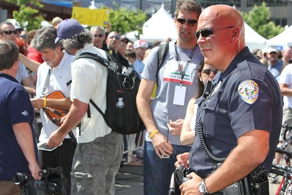 Visalia police monitor the huge, curious crowd at the Radioshack bus this morning.
