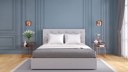Grey stylish bedroom with bed and pillows