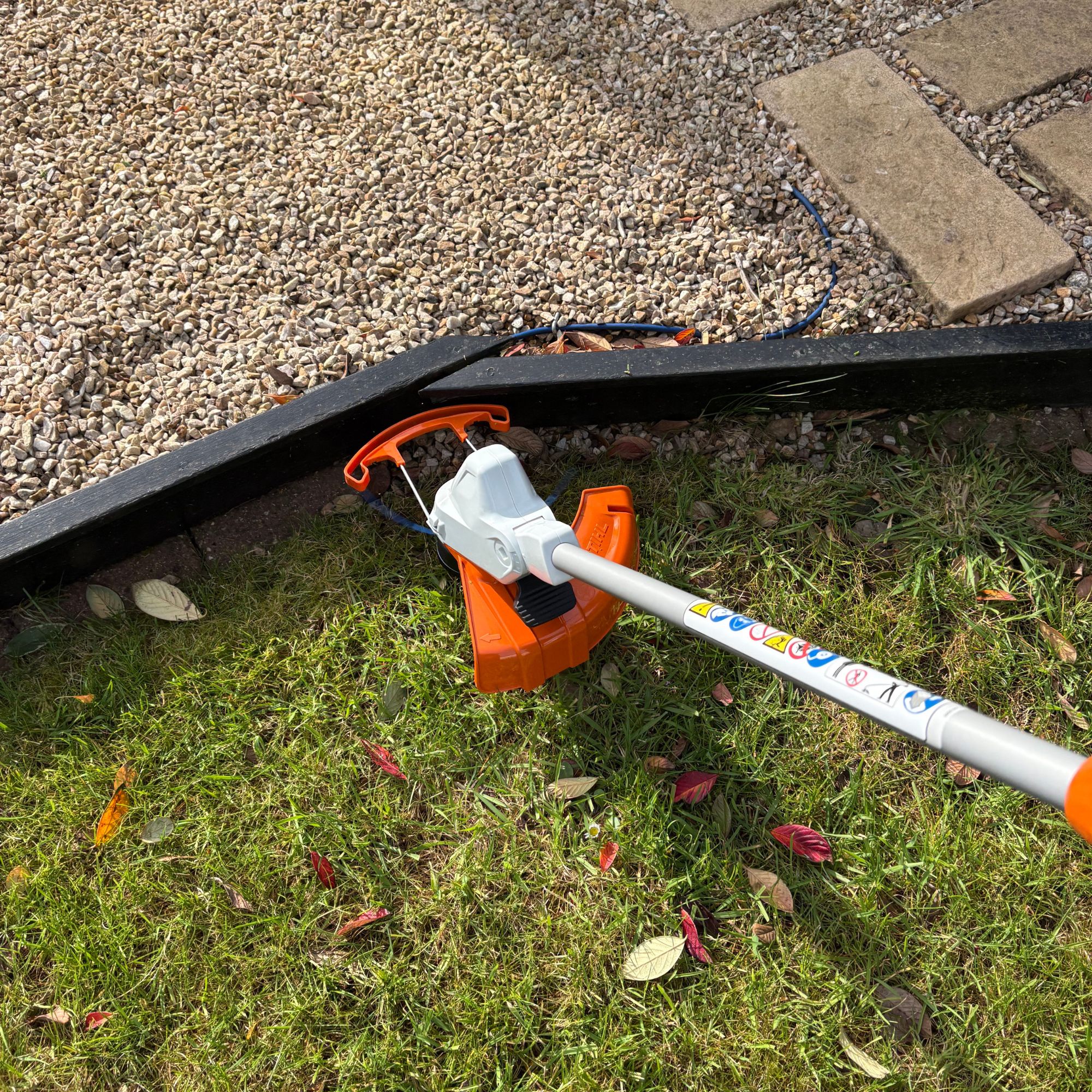 STIHL FSA 50 Cordless Grass Trimmer cutting lawn in garden