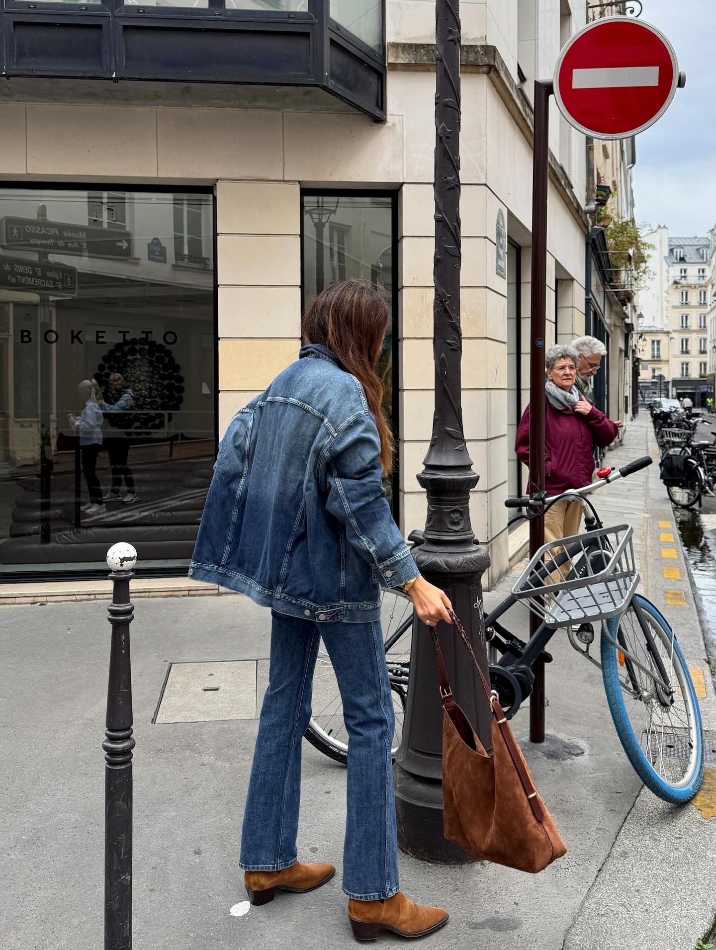 Woman wearing jeans with pointed-toe suede ankle boots