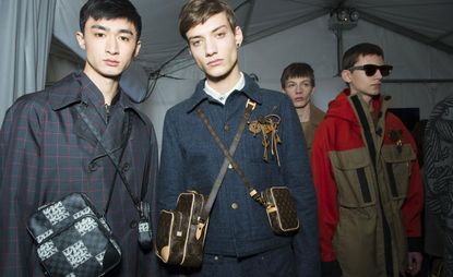 2 male models looking towards the camera in Louis Vuitton clothing & accessories