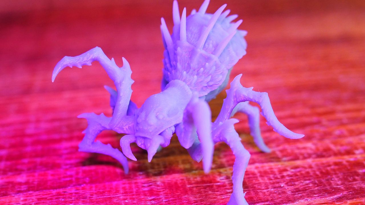 A 3D printed spider on a wooden table