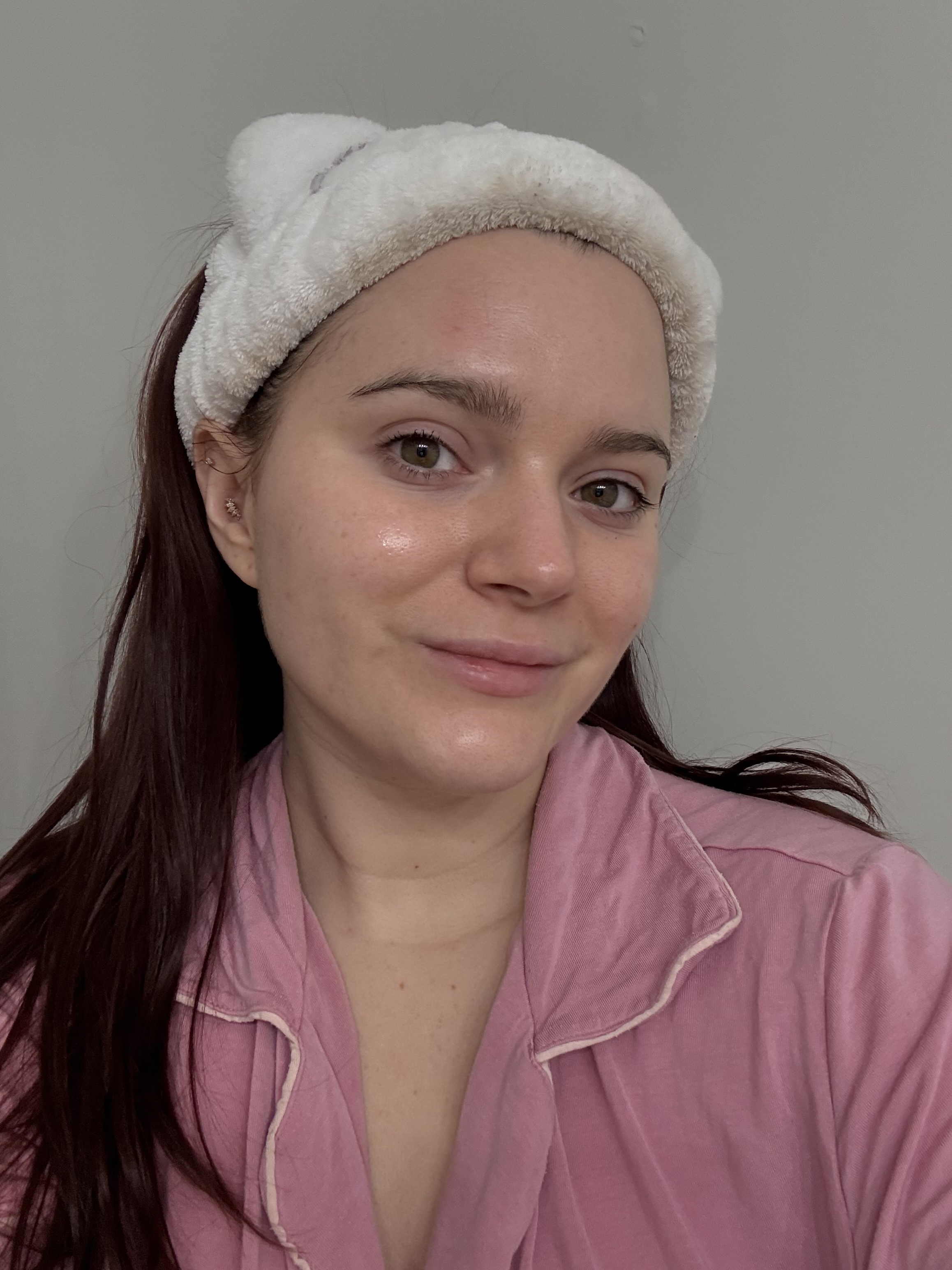 girl with glowing skin and a pink shirt after a face mask