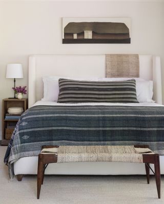 white bed with striped throw