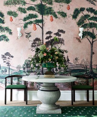 A vibrant mural-style wallpaper in pink and green, as an example of how to hang wallpaper in a Chinese-inspired scheme.