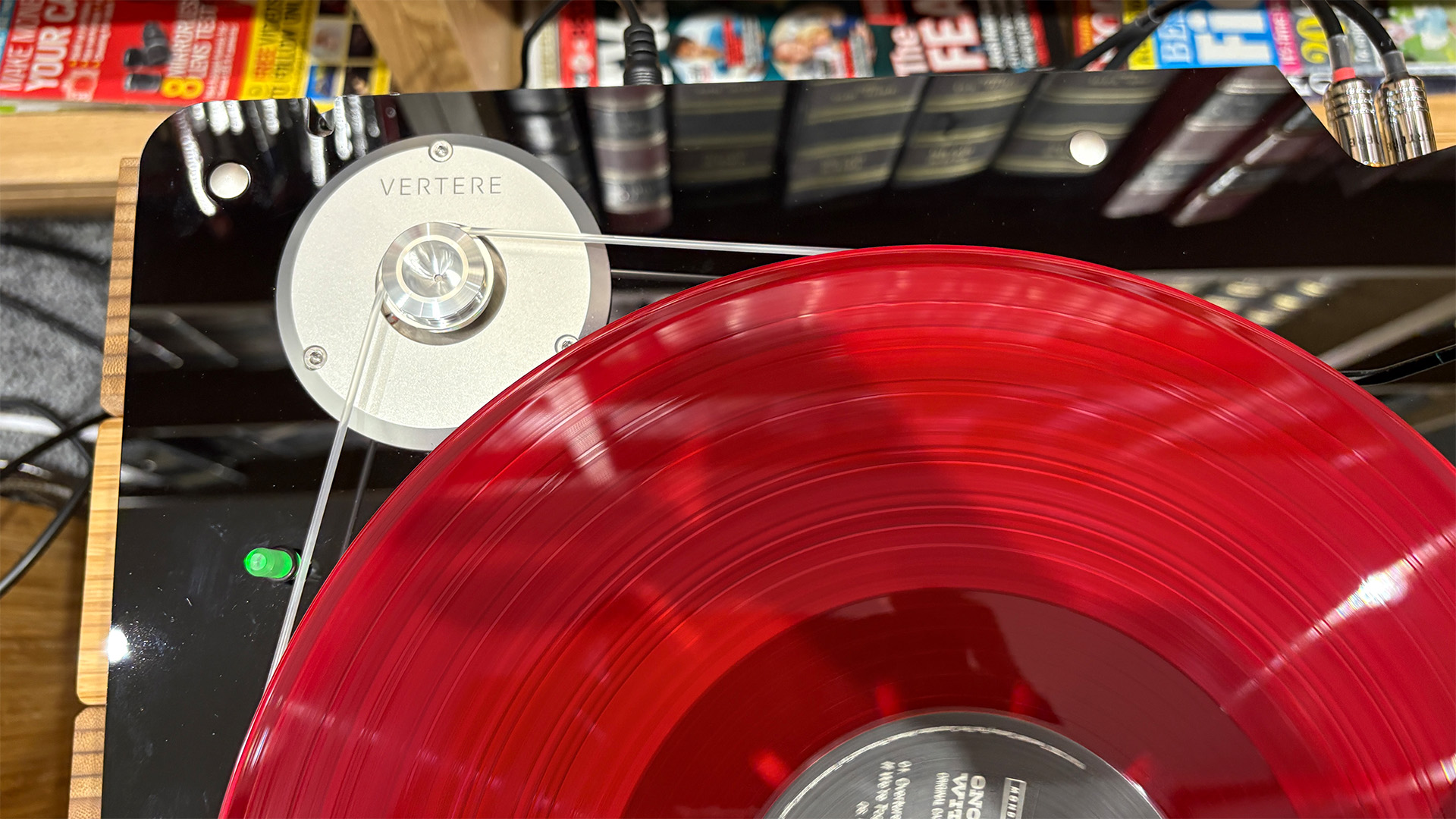 Vertere DG-X turntable from above, detail of belt and edge of pink vinyl record