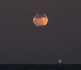 The full Strawberry Moon of June 2024 shines over Fort Lauderdale Beach in Florida despite a cloudy sky in this photo by Lisa Shislowski on June 21, 2024.