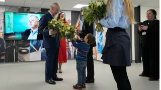 Britain's King Charles III receives flowers as he visits the University of East London to mark the University's 125th anniversary and open a new frontline medical teaching hub on February 8, 2023 in London, England.