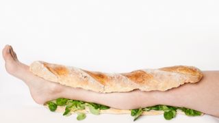 A stock photo of a sandwich with human leg filling.