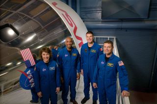 Artemis II crew members (from left) Christina Koch, Victor Glover, Jeremy Hansen and Reid Wiseman pose by an Orion spacecraft simulator at NASA's Johnson Space Center.