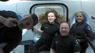 The Inspiration4 crew inside the SpaceX's Dragon Crew Resilience free floating in orbit and posing for a group photo
