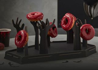 An image of the Coffin & Zombie Arms Donut Stand from Party Pieces, one of the best Halloween decorations for 2022