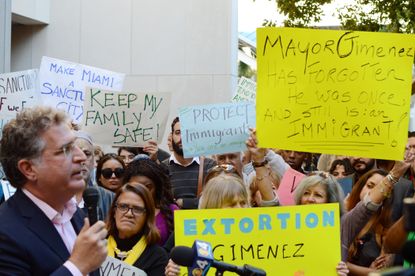 Former Democratic Florida congressman Joe Garcia speaks to protesters outside of Miami-Dade County hall in Miami, Florida.