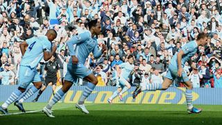 Manchester City's Bosnian striker Edin Dzeko (R) runs back to the half-way line after scoring his goal during the English Premier League football match between Manchester City and Queens Park Rangers at The Etihad stadium in Manchester, north-west England on May 13, 2012. AFP PHOTO/PAUL ELLIS RESTRICTED TO EDITORIAL USE. No use with unauthorized audio, video, data, fixture lists, club/league logos or 'live' services. Online in-match use limited to 45 images, no video emulation. No use in betting, games or single club/league/player publications. (Photo credit should read PAUL ELLIS/AFP/GettyImages)